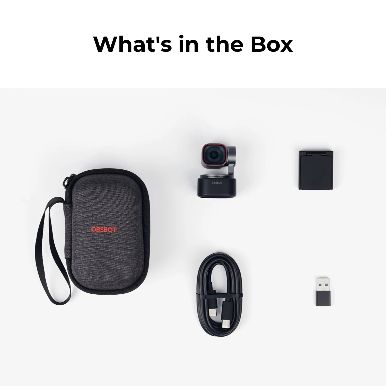 List of items included in a box with a carrying case, camera, battery, cable, and USB drive on a white background.